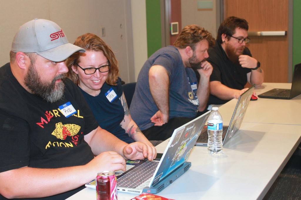 Attendees pairing at laptops to build their first n8n workflows
